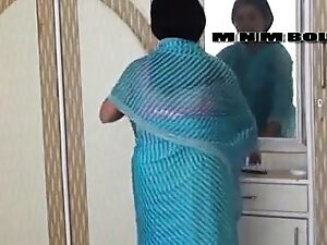 A mature Desi aunty with impressive breasts enjoys a close encounter with a douche during a steamy bath.
