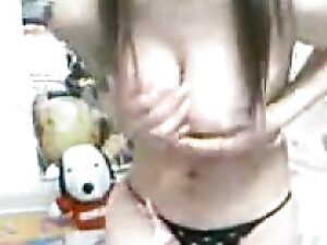 An Asian beauty reveals her hidden secret on webcam by stuffing her bra with balloons.